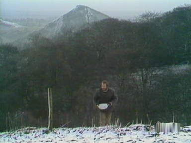 Charles makes his way back to Fenton's house carrying water from the weir