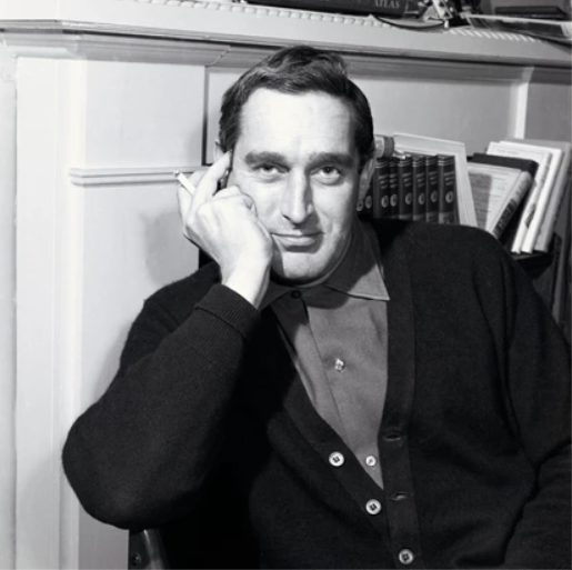 Terry Nation, posing at a writing desk and holding a cigarette